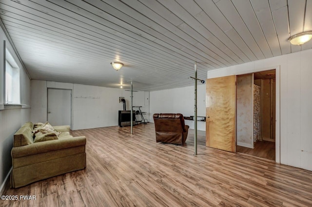 living area with wood ceiling and wood finished floors