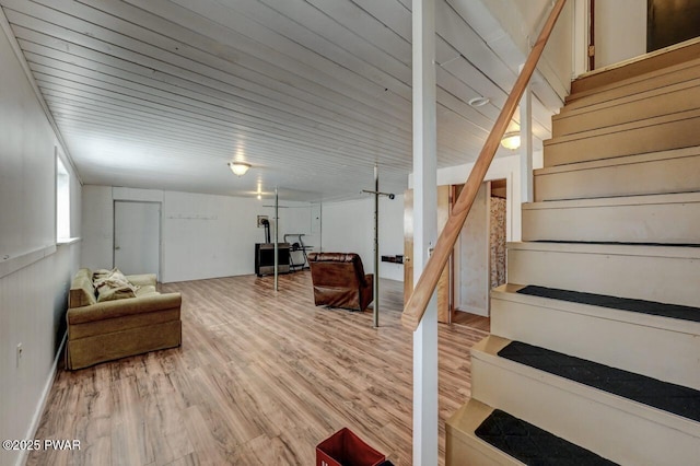 basement with stairway and light wood-style floors