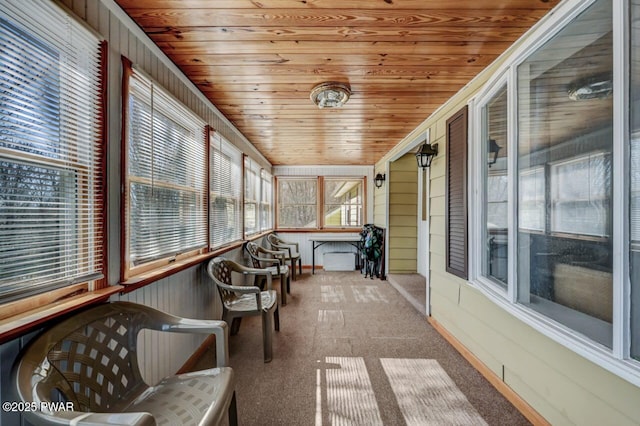 unfurnished sunroom featuring wooden ceiling