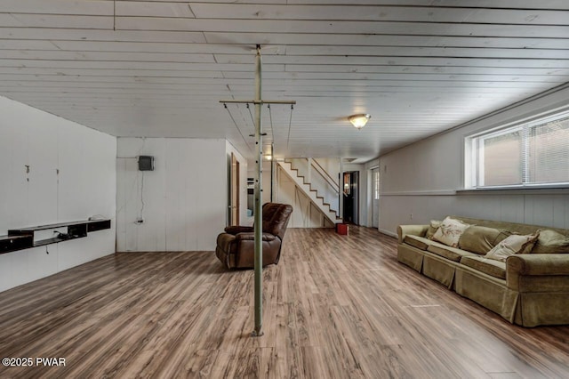 interior space with stairway, wood finished floors, and wooden ceiling