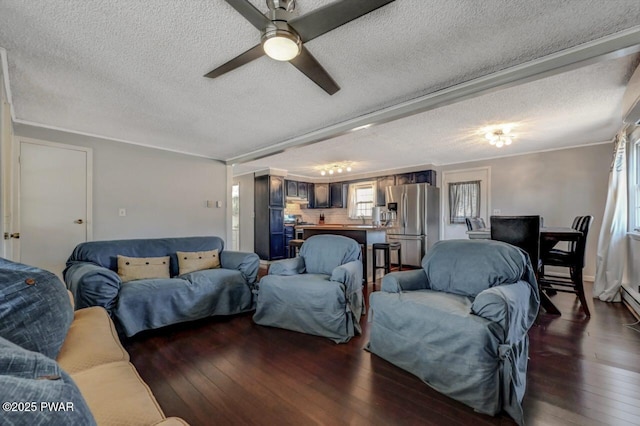 living area with dark wood finished floors, a textured ceiling, crown molding, and a ceiling fan