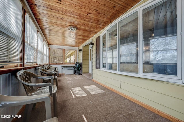 unfurnished sunroom featuring wood ceiling