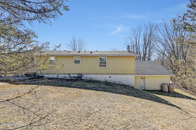 rear view of house featuring roof with shingles