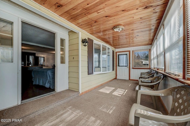 unfurnished sunroom with wood ceiling