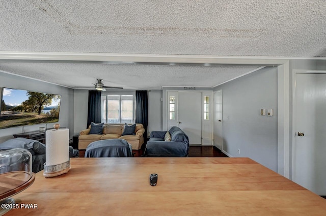 dining area featuring a textured ceiling, ceiling fan, and ornamental molding