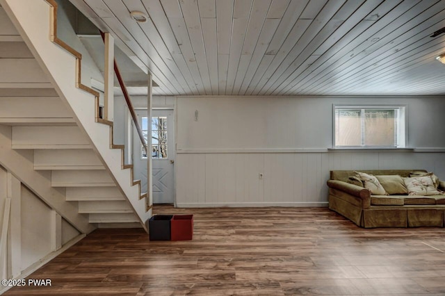 below grade area with stairway, wood finished floors, a healthy amount of sunlight, and wooden ceiling