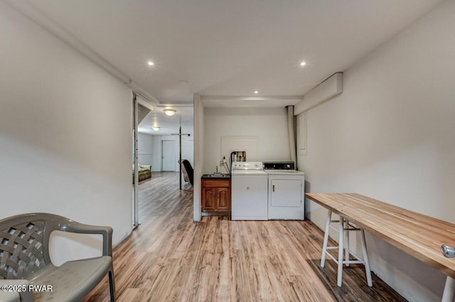 kitchen with recessed lighting, separate washer and dryer, and light wood-style flooring