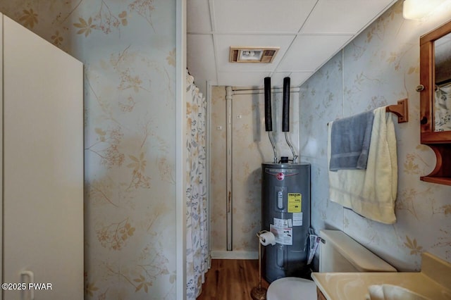 utility room featuring visible vents and water heater