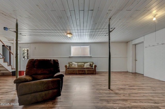 interior space featuring stairway, a healthy amount of sunlight, and wood finished floors