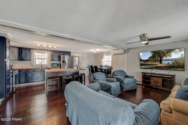 living room with a textured ceiling, an AC wall unit, and dark wood-type flooring