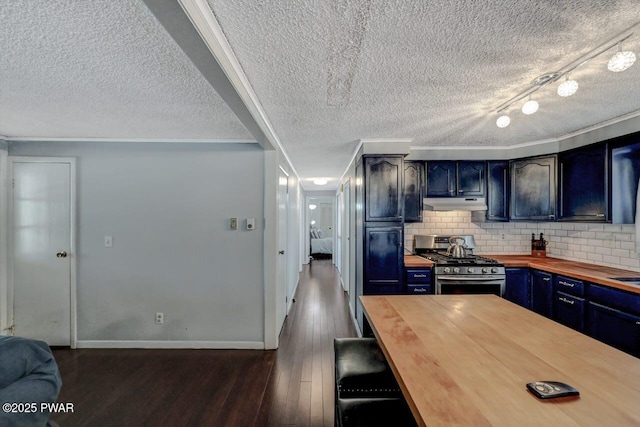 kitchen with stainless steel gas range oven, backsplash, wooden counters, dark wood-style floors, and blue cabinets