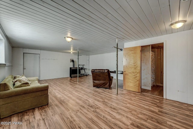 living area with wood finished floors and wooden ceiling