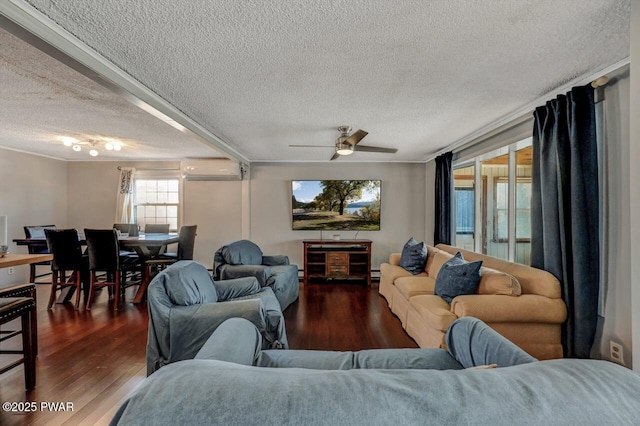 living room with a baseboard heating unit, an AC wall unit, wood finished floors, a textured ceiling, and a ceiling fan