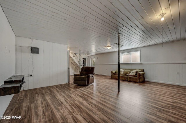 basement featuring wood ceiling, wood finished floors, and stairs