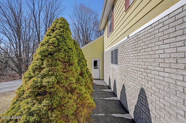 view of property exterior featuring brick siding