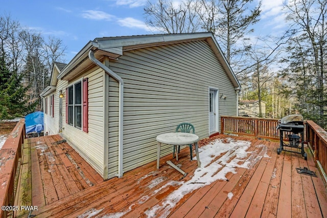 wooden deck with a grill