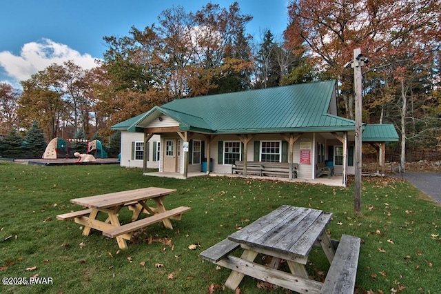 view of front of home featuring a front yard and a patio