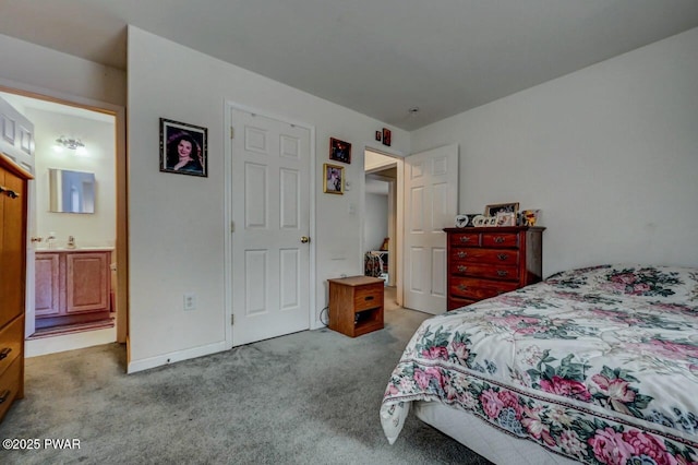 bedroom with ensuite bath and light colored carpet