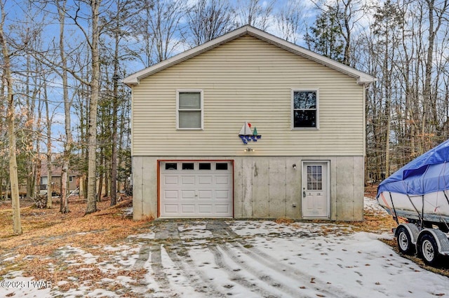 view of snow covered exterior featuring a garage