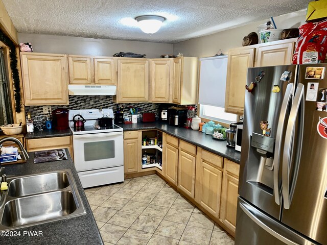 kitchen with sink, stainless steel refrigerator with ice dispenser, light tile patterned floors, a textured ceiling, and white electric range oven