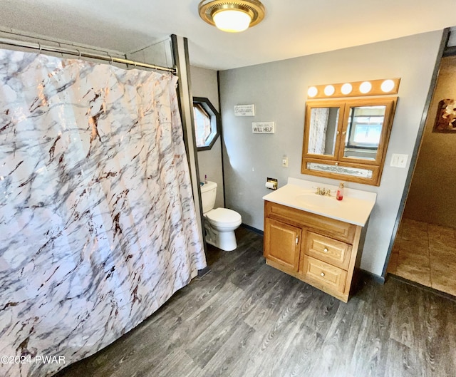 bathroom featuring a shower with curtain, vanity, wood-type flooring, and toilet