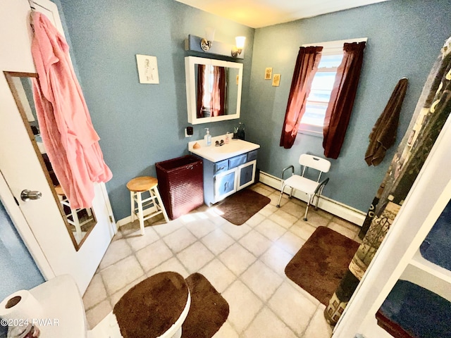 bathroom with tile patterned flooring, vanity, and a baseboard heating unit