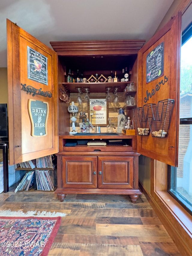 bar featuring dark wood-type flooring