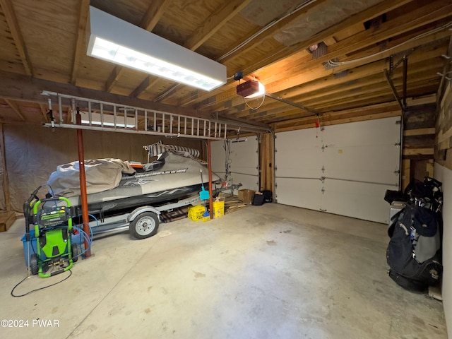 garage featuring a garage door opener and a carport