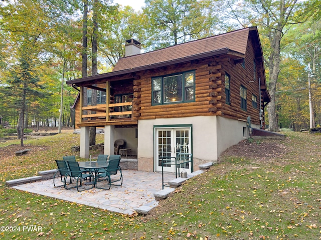 rear view of house with a yard, a patio, and french doors