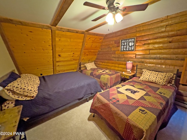 carpeted bedroom featuring ceiling fan, beam ceiling, and log walls