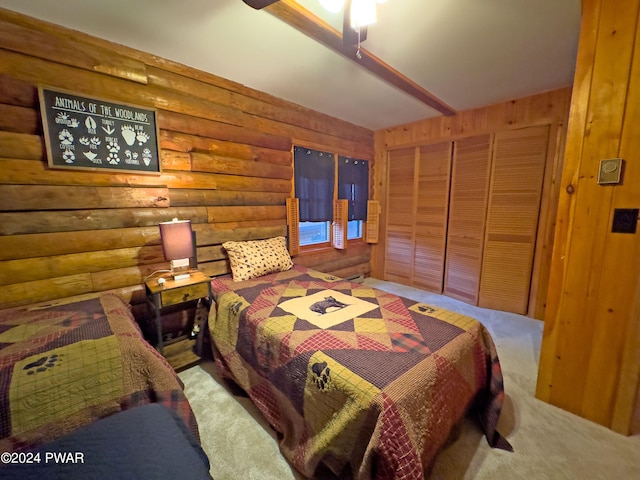 bedroom with carpet flooring, rustic walls, and a closet