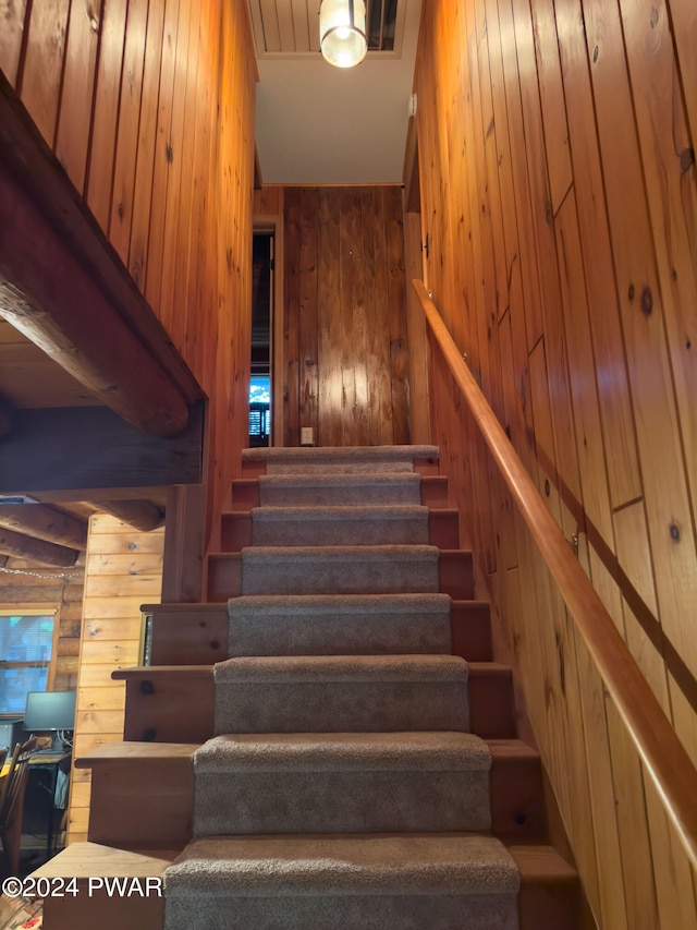 stairway with wood walls and rustic walls