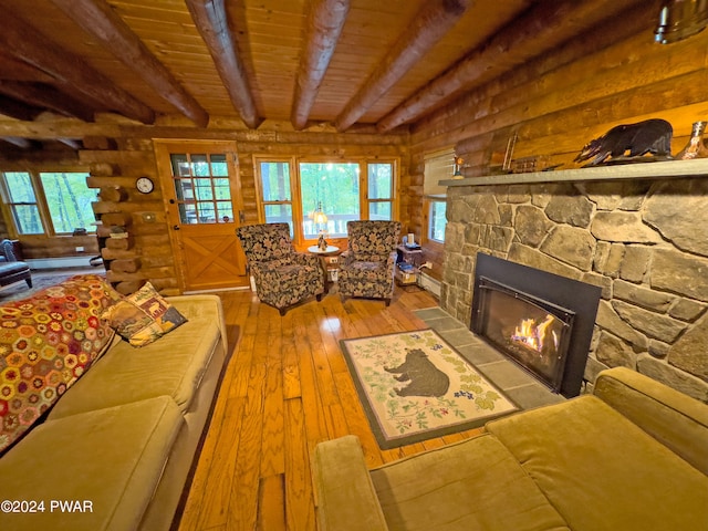 unfurnished living room with beam ceiling, log walls, wooden ceiling, light hardwood / wood-style flooring, and a fireplace