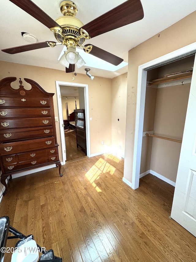 unfurnished bedroom with a closet, ceiling fan, and hardwood / wood-style flooring