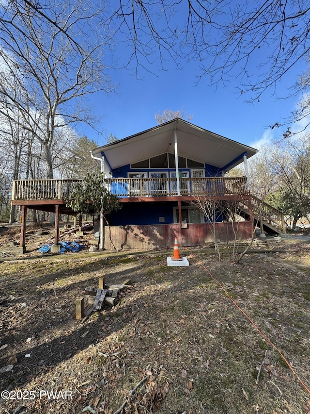 rear view of house featuring a deck