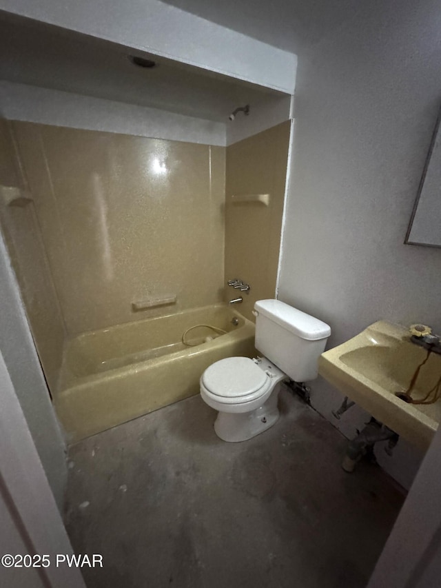 full bathroom with toilet, concrete floors, shower / bathtub combination, and sink