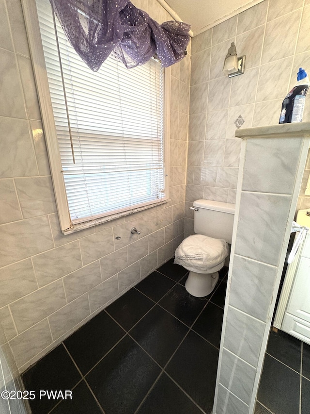 bathroom featuring tile walls, toilet, and tile patterned floors