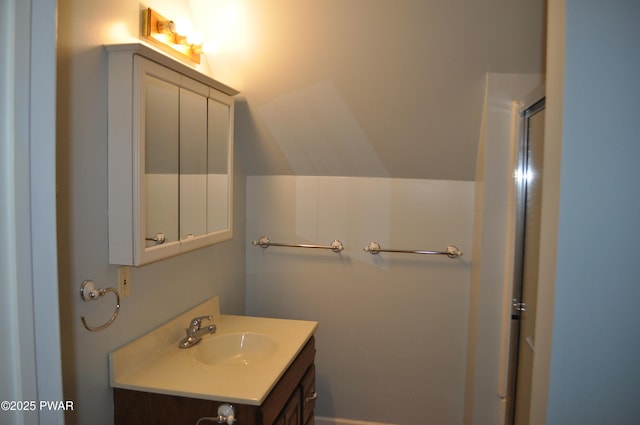 bathroom with lofted ceiling and vanity