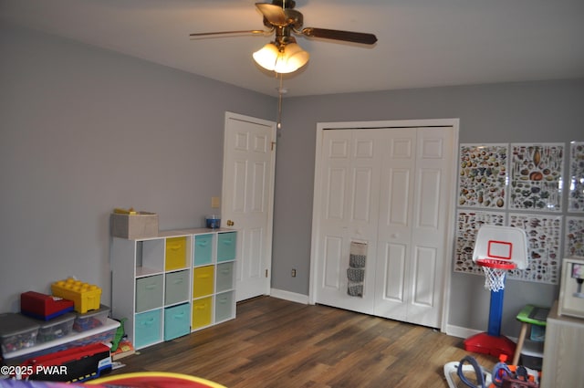 recreation room with ceiling fan, baseboards, and wood finished floors