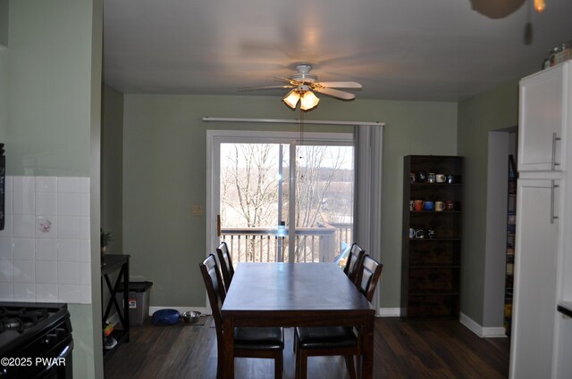 dining room featuring ceiling fan, baseboards, and dark wood-type flooring