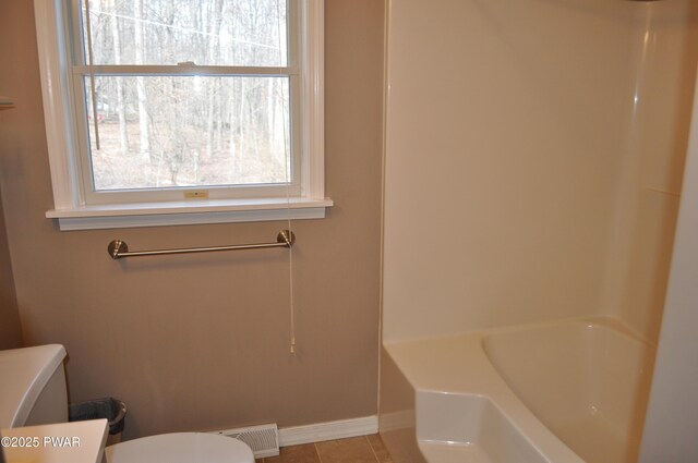 bathroom with baseboards, visible vents, toilet, tile patterned floors, and vanity