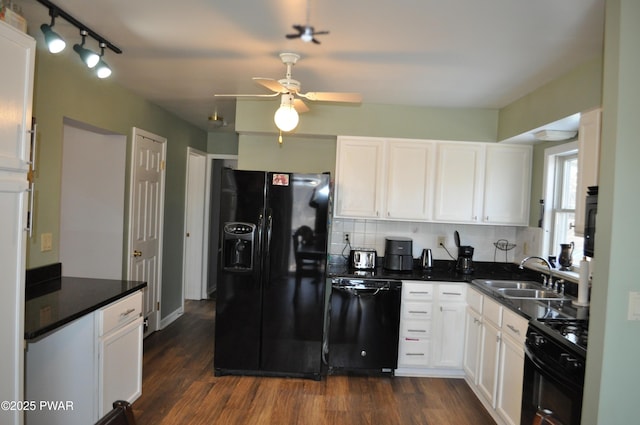 kitchen with a sink, white cabinetry, dark wood-style floors, black appliances, and dark countertops