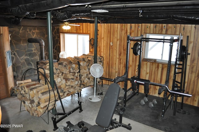 workout area featuring plenty of natural light and wooden walls