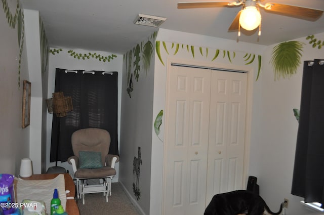 sitting room featuring visible vents and carpet flooring