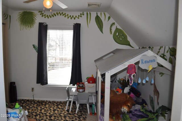 interior space featuring vaulted ceiling, multiple windows, and visible vents