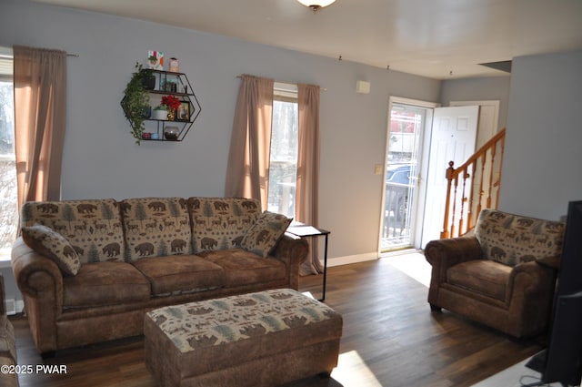 living room featuring baseboards, stairway, and dark wood-type flooring