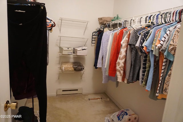 walk in closet featuring a baseboard radiator and carpet floors