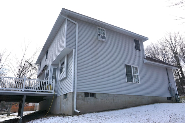 view of snow covered exterior with a wooden deck