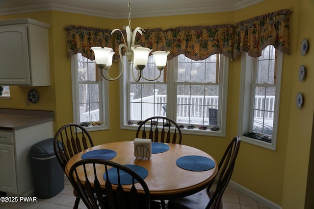 tiled dining space with ornamental molding and a chandelier