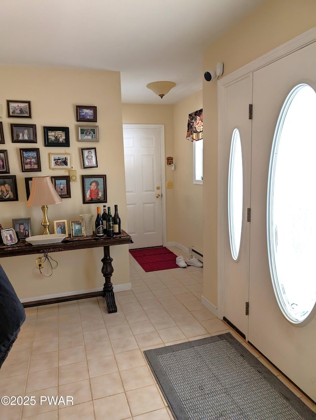 entryway with light tile patterned floors and a baseboard radiator